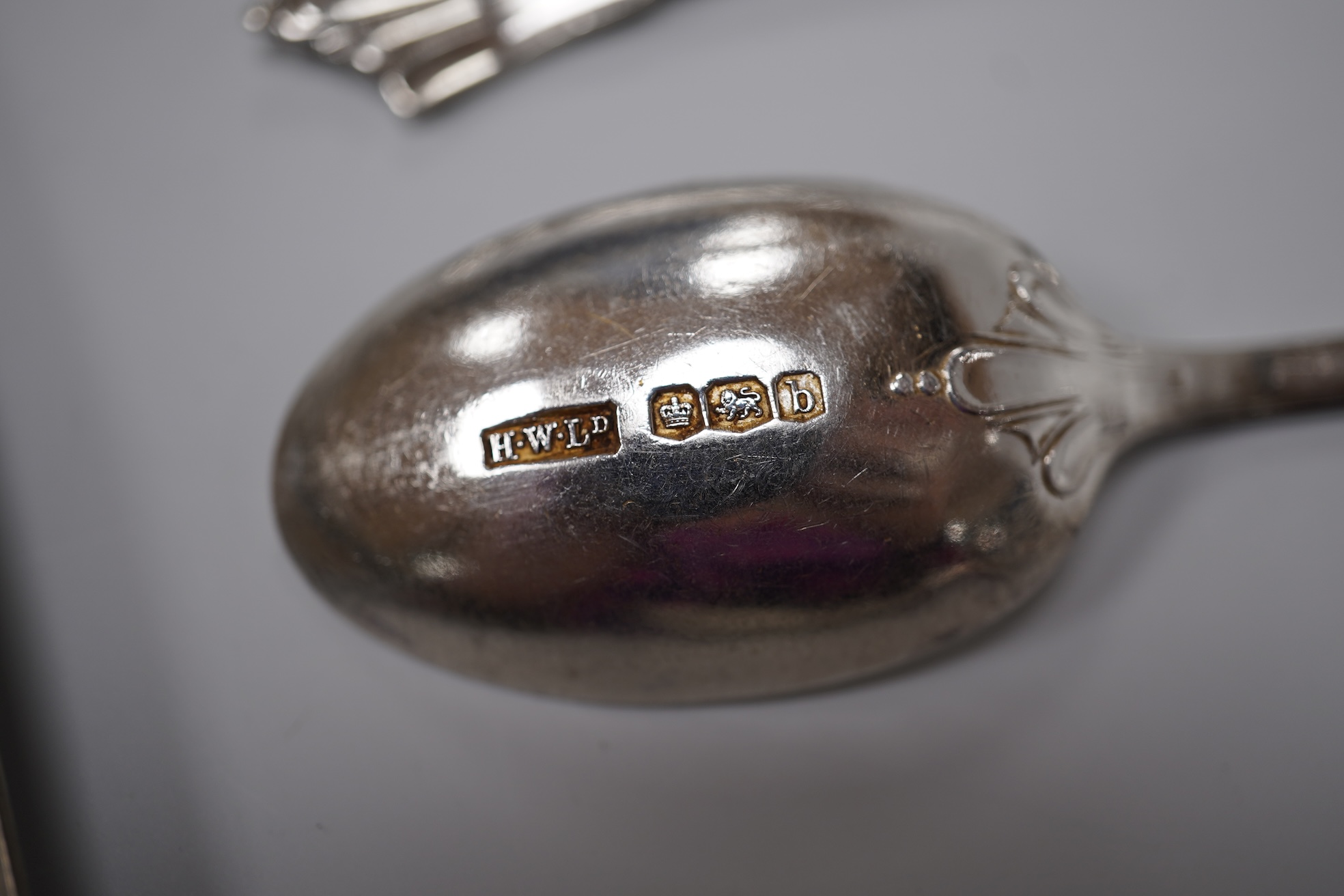 A group of mixed silver including a lidded Wedgwood jug, height 22.5cm (a.f.), mounted hand mirror, two mounted brushes, a mounted capstan inkwell, Edwardian miniature ewer on stand, tortoiseshell pique trinket box, etc.